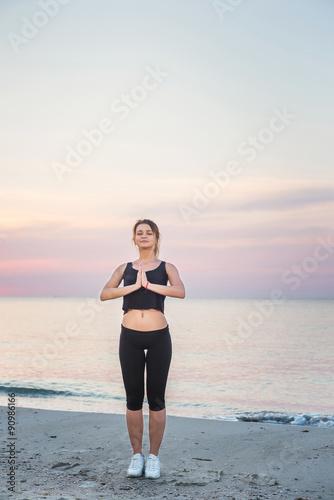  Fitness sport model smiling happy doing exercises during outdoor work out on sunrise. Beautiful caucasian female training outside on seaside in the morning