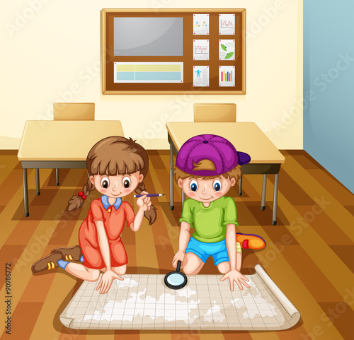 Children reading map in classroom