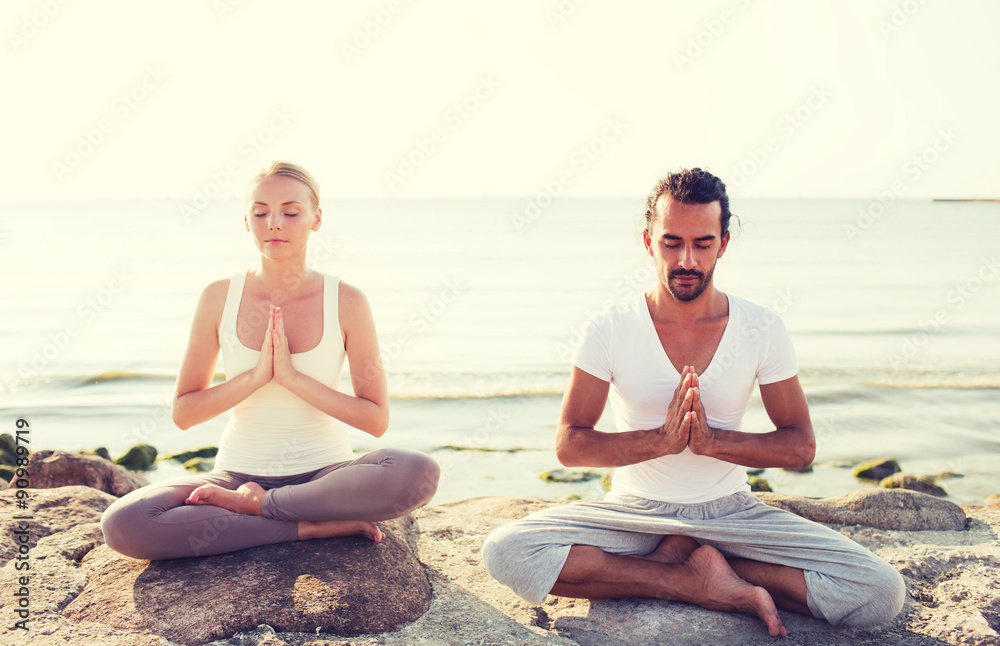 smiling couple making yoga exercises outdoors smiling couple making yoga exercises outdoors