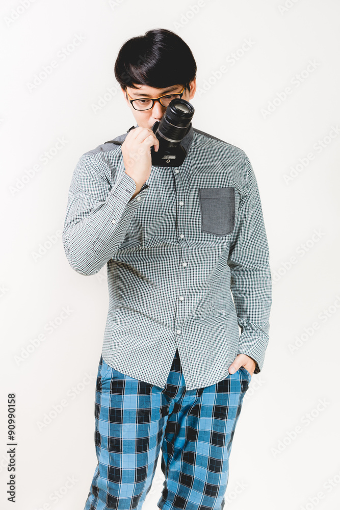 Young confident hipster man with beard posing on the white backg Young confident hipster man with beard posing on the white backg