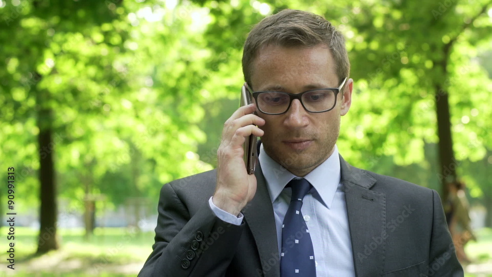 Businessman having a conversation on cellphone in the park
Businessman having a conversation on cellphone in the park
