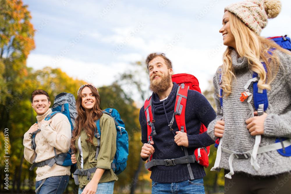 smiling friends with backpacks hiking over nature smiling friends with backpacks hiking over nature