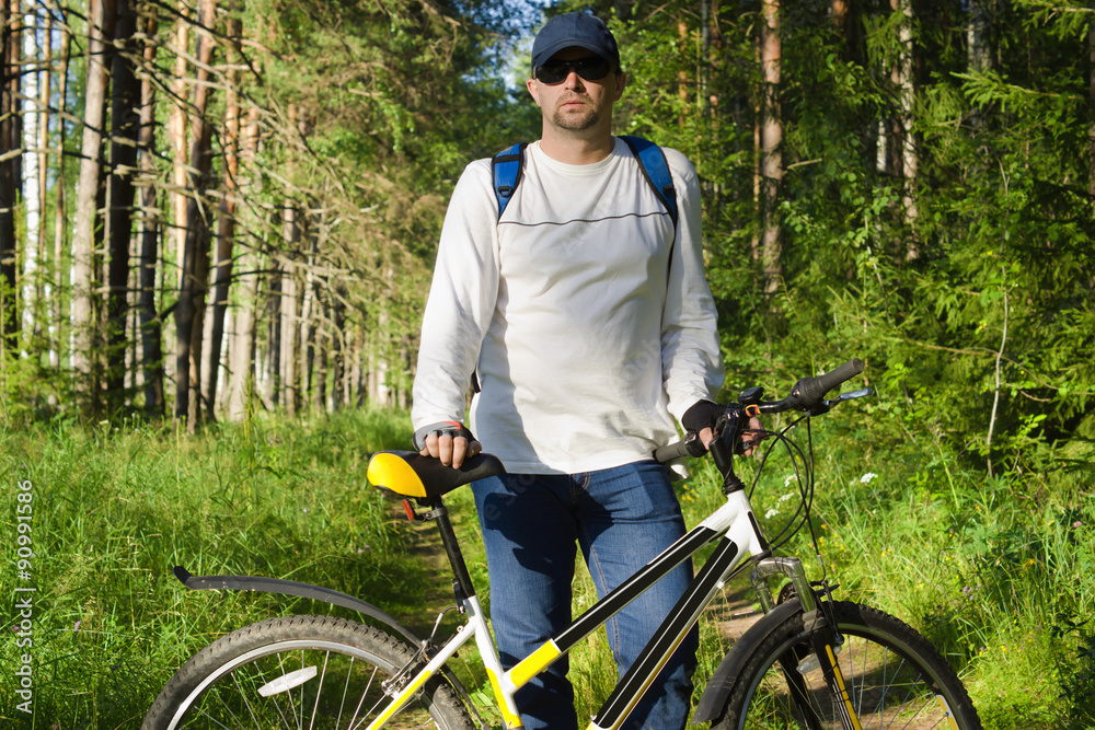 Handsome man biking in the countryside