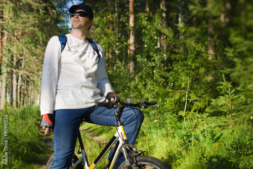 Fototapeta Naklejka Na Ścianę i Meble -  Handsome man biking in the countryside