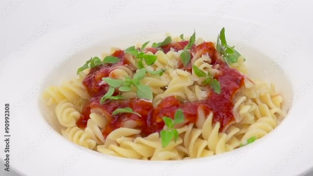 Dish with pasta and tomato souce on white background Dish with pasta and tomato souce on white background