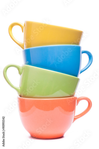 Four cups stacked. Colored mugs. Colorful image with tableware.