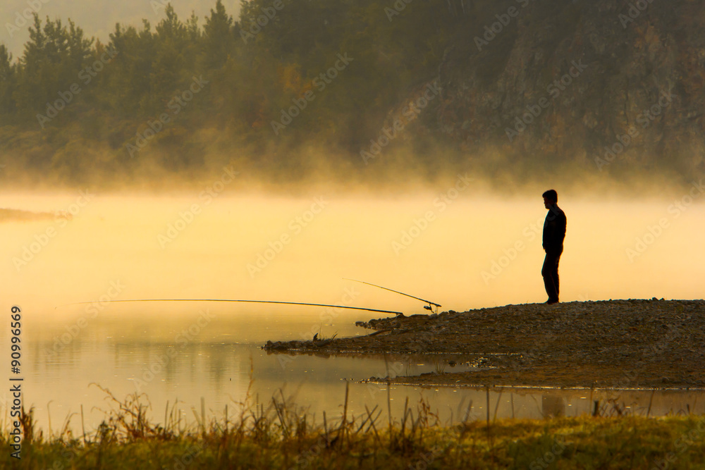 Man Fishing at river shore