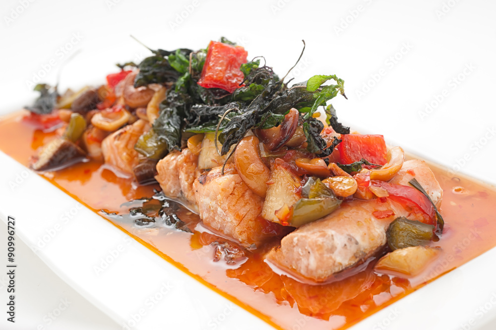 Fried fish with basil leaves and cashew nuts isolated on white Fried fish with basil leaves and cashew nuts isolated on white