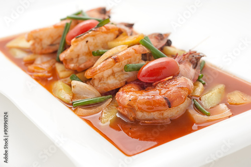 Fried shrimps with sweet and sour sauce isolated on white