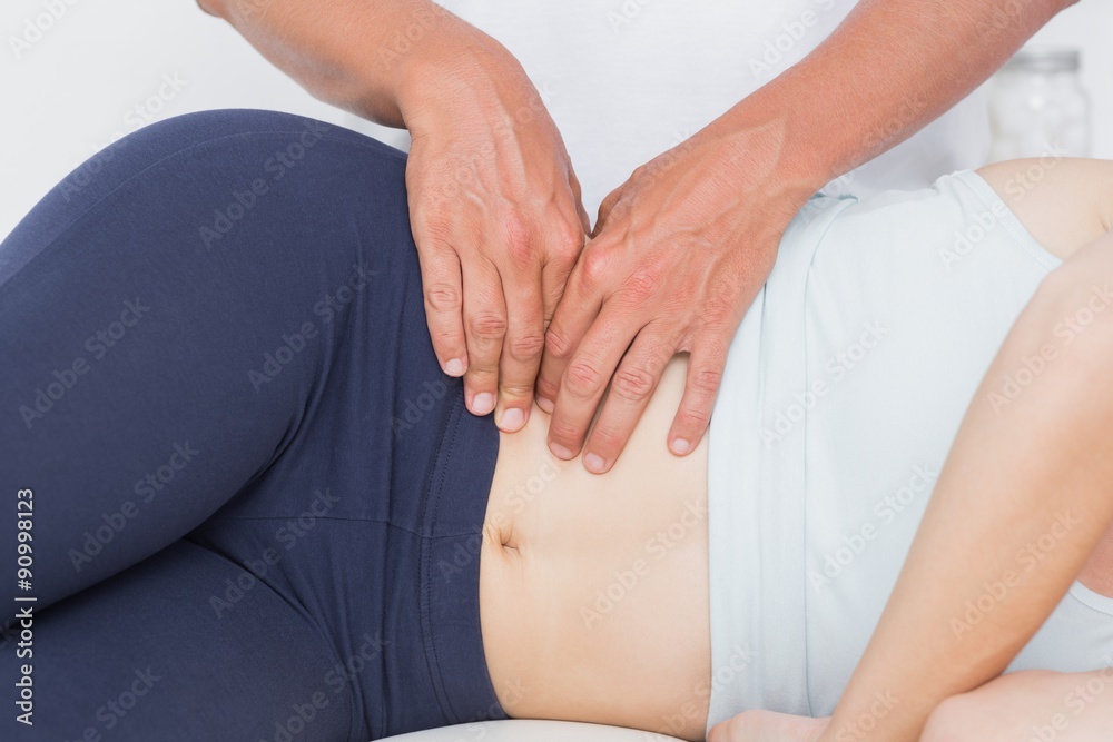 Doctor examining his patient pelvis Doctor examining his patient pelvis