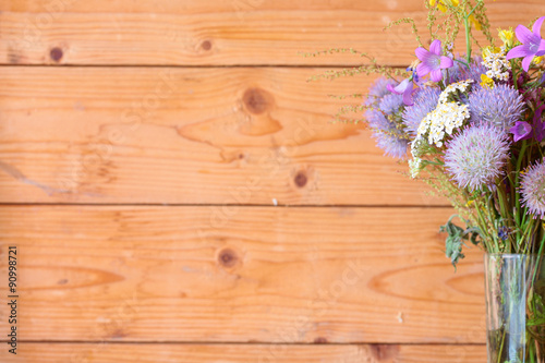 Wooden background, bouquet of flowers in focus