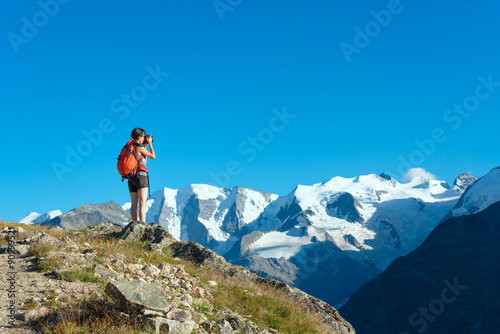 Girl Photographs high mountains of the Alps