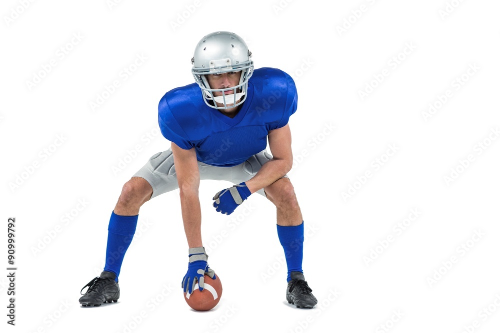 Alert American football player in attack stance Alert American football player in attack stance