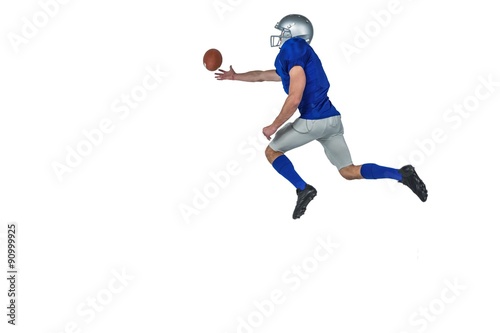 American football player trying to catch the ball © WavebreakmediaMicro