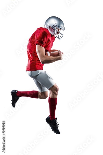 American football player holding ball while running