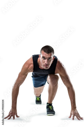 Full length portrait of runner ready to race