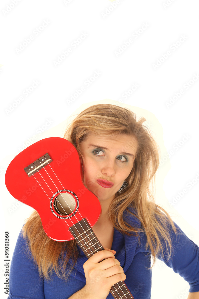Fototapeta premium Blond woman holding a ukulele to her face