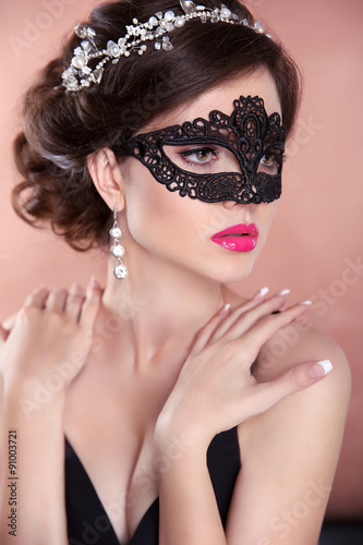 Beauty fashion girl model with mask. Makeup. Hairstyle. Jewelry.