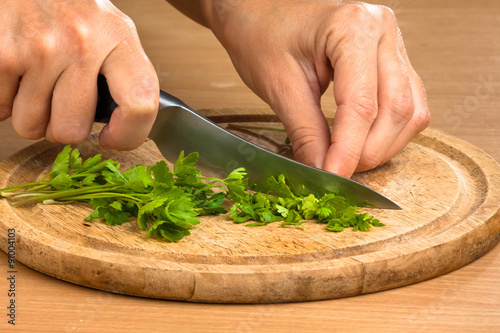 hands chopping parsley leaves