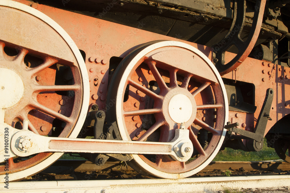 Old locomotive wheels close up.