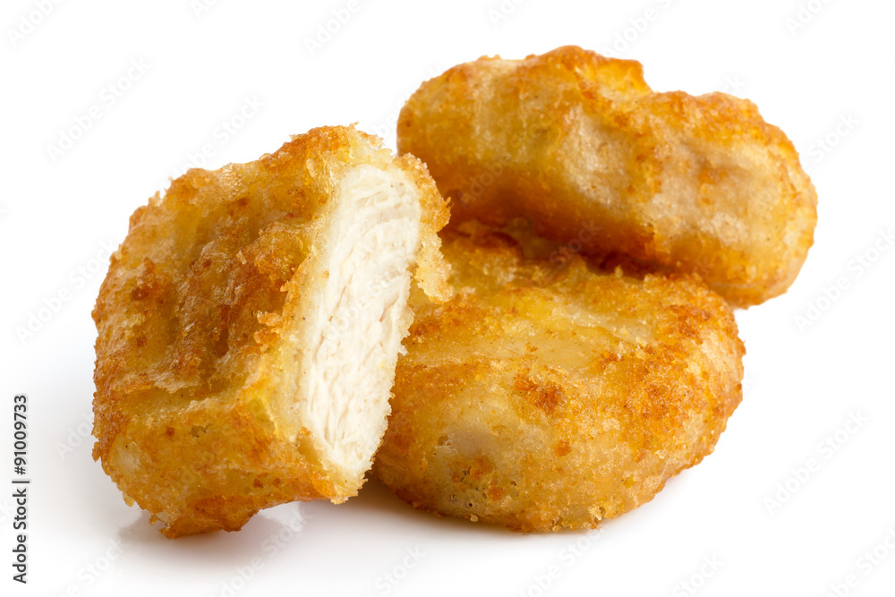 Three golden deep-fried battered chicken nuggets isolated on whi Three golden deep-fried battered chicken nuggets isolated on whi