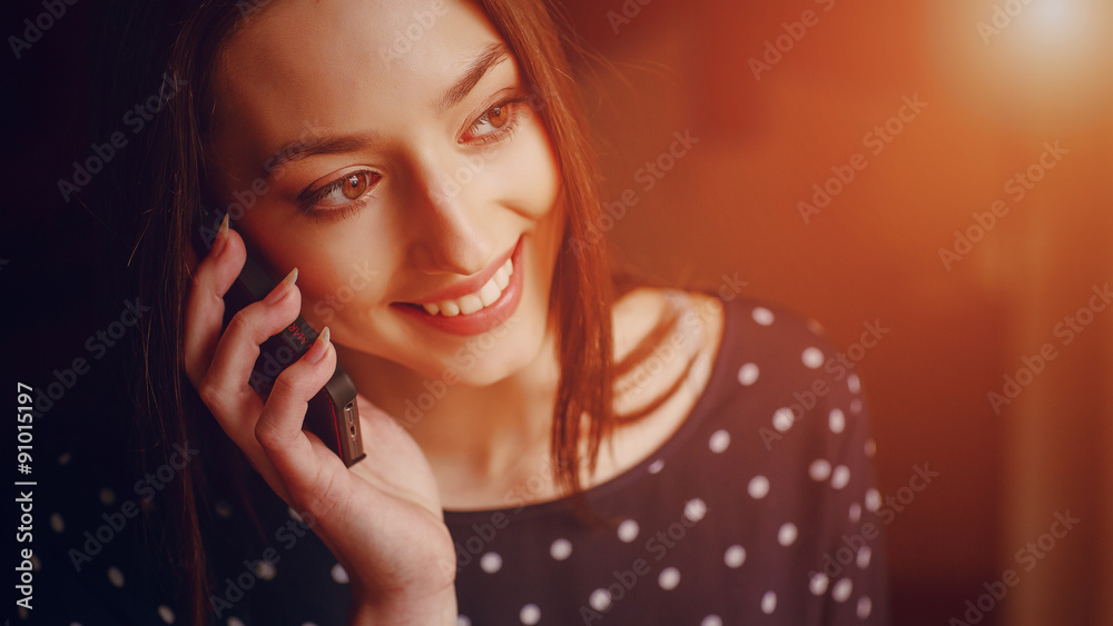 Fototapeta premium beautiful young girl enjoys phone and tablet