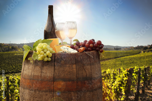 Fototapeta Naklejka Na Ścianę i Meble -  White wine with barrel on vineyard in Chianti, Tuscany, Italy