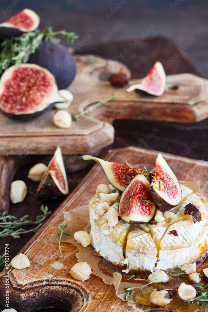 Baked Camembert with Figs, hazelnuts and thyme.selective focus Baked Camembert with Figs, hazelnuts and thyme.selective focus