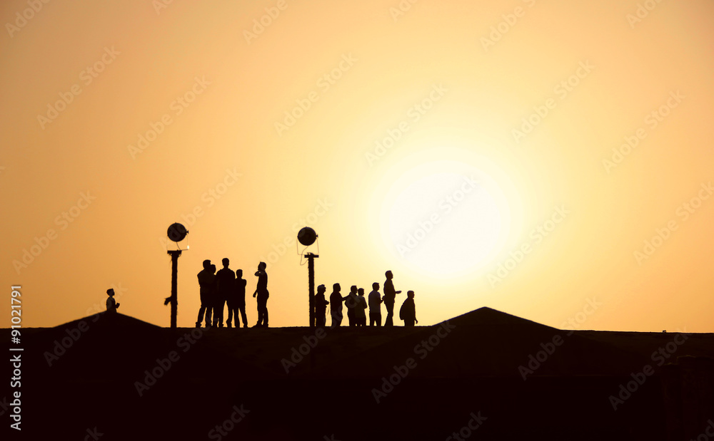 Silhouettes of people in the desert at sunset, hiking Silhouettes of people in the desert at sunset, hiking
