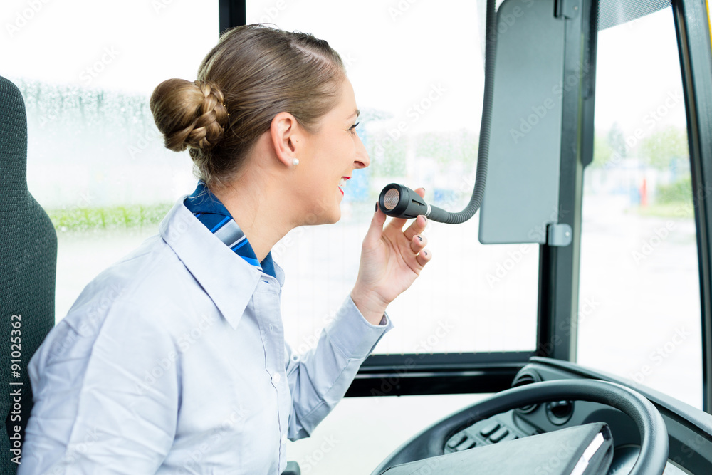 Busfahrererin spricht in Bus Mikrofon und macht eine Durchsage Stock Photo  | Adobe Stock