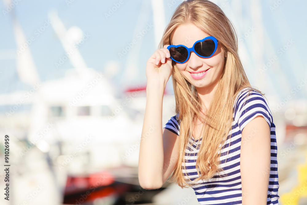 woman in marina against yachts in port woman in marina against yachts in port