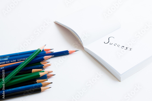 Success concept write down in a white paper book with pencil and used eraser on white paper book