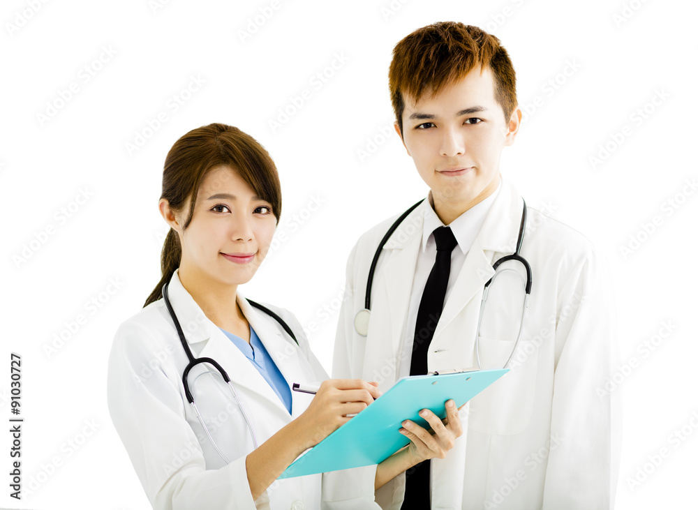 smiling male and female doctors standing together smiling male and female doctors standing together