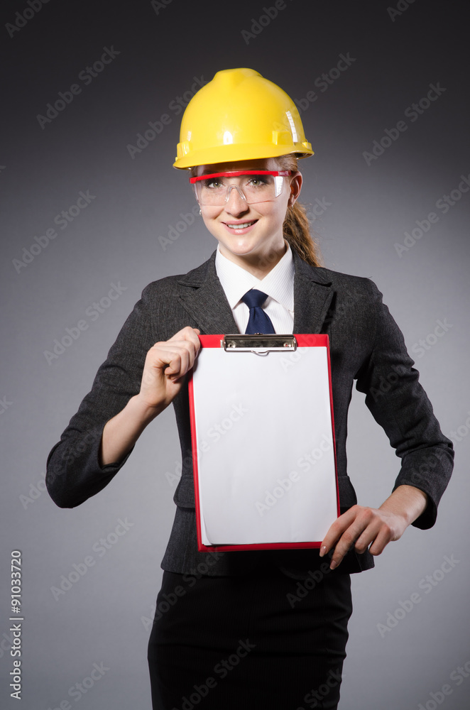 Construction worker in helmet against gray Construction worker in helmet against gray