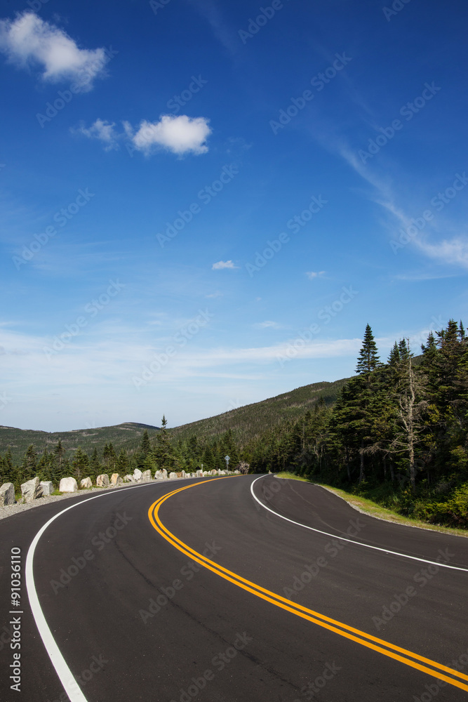 Winding road in Adirondack mountains, upstate New York, USA. Transportation, travel, explore, vacation, summer, destination, driving and nature concept
