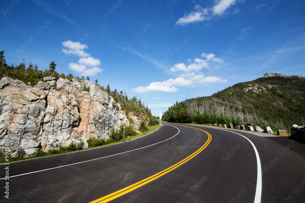 Winding road in Adirondack mountains, upstate New York, USA. Transportation, travel, explore, vacation, summer, destination, driving and nature concept
