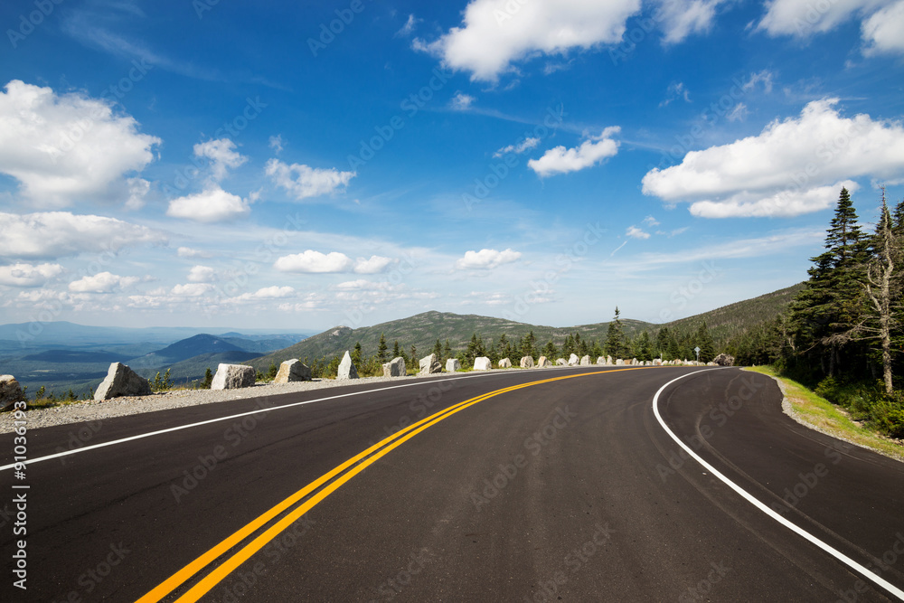 Winding road in Adirondack mountains, upstate New York, USA. Transportation, travel, explore, vacation, summer, destination, driving and nature concept