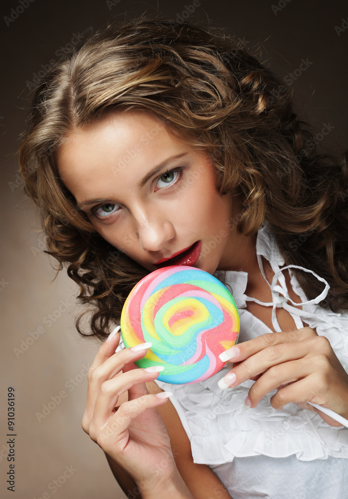 Young woman with colorful lollipop 