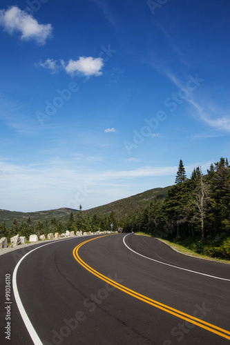 Winding road in Adirondack mountains  upstate New York  USA. Transportation  travel  explore  vacation  summer  destination  driving and nature concept