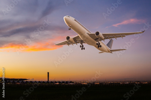 Commercial airplane take off at sunset