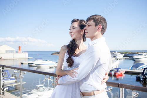 bride and groom on the background of yacht club, young happy