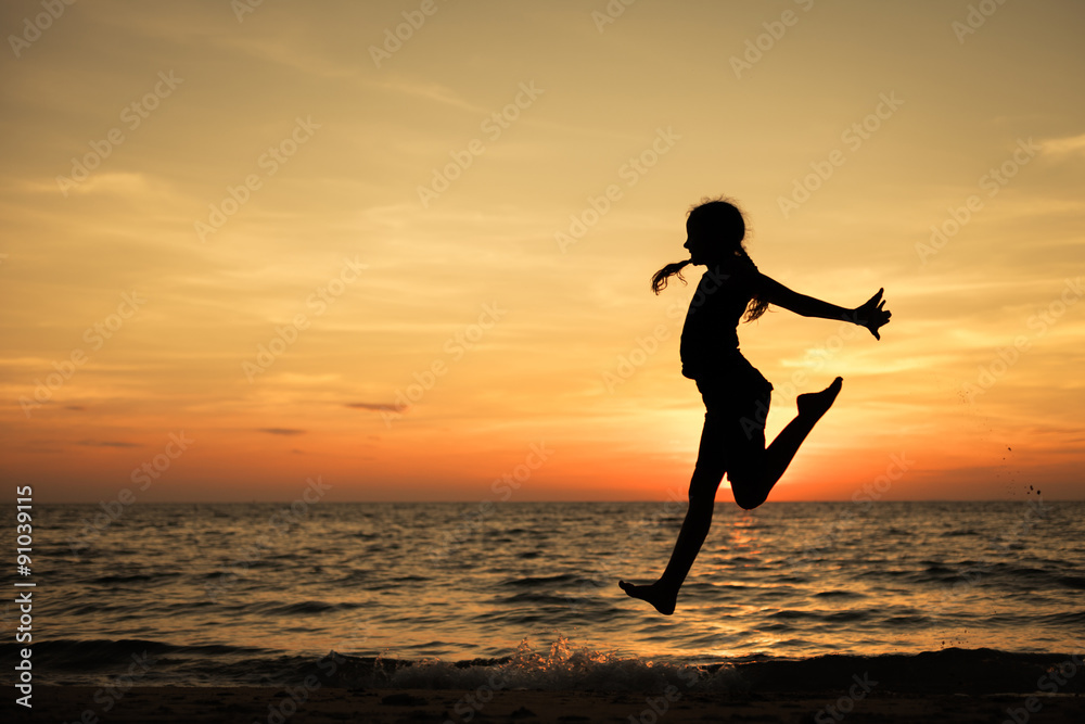 Happy teen girl  jumping on the beach
