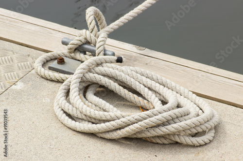 Yachting, white rope and mooring bollard © ratmaner