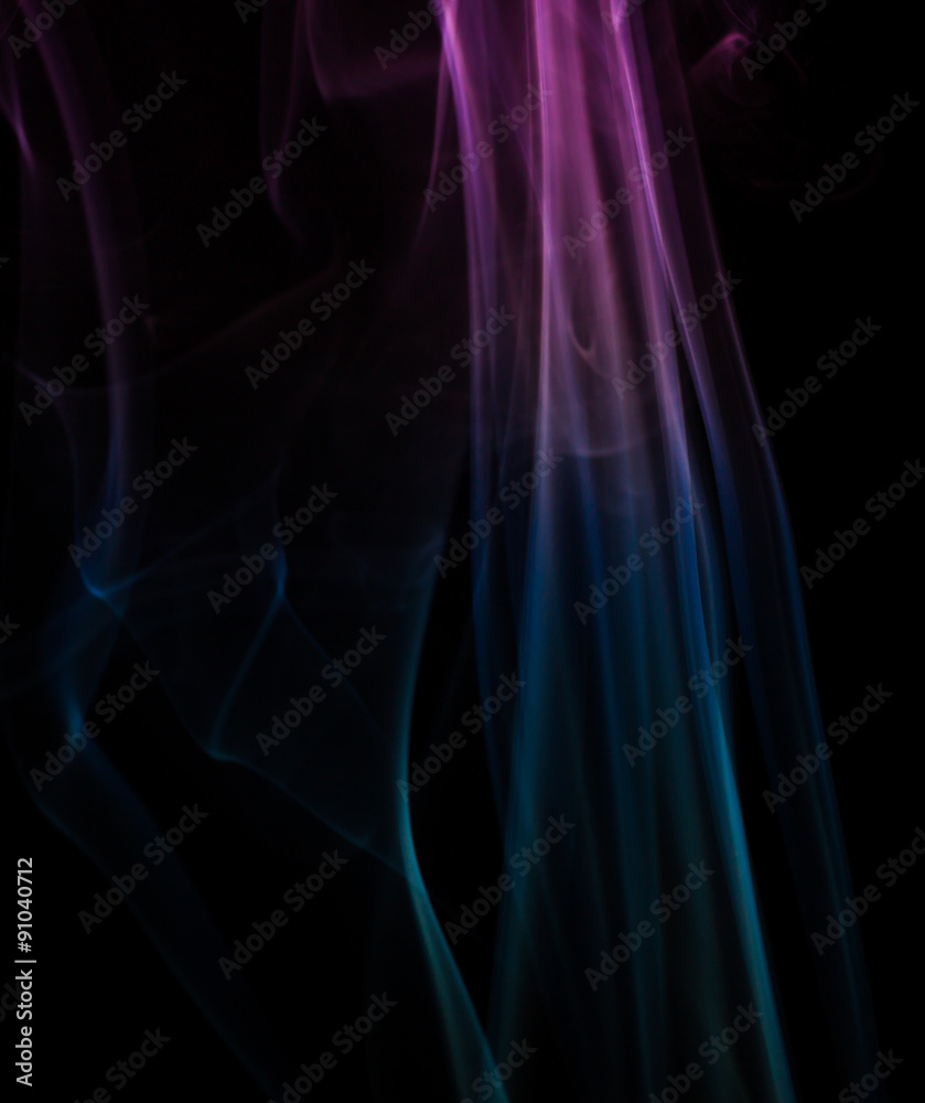 Abstract colored smoke floating on dark background Abstract colored smoke floating on dark background