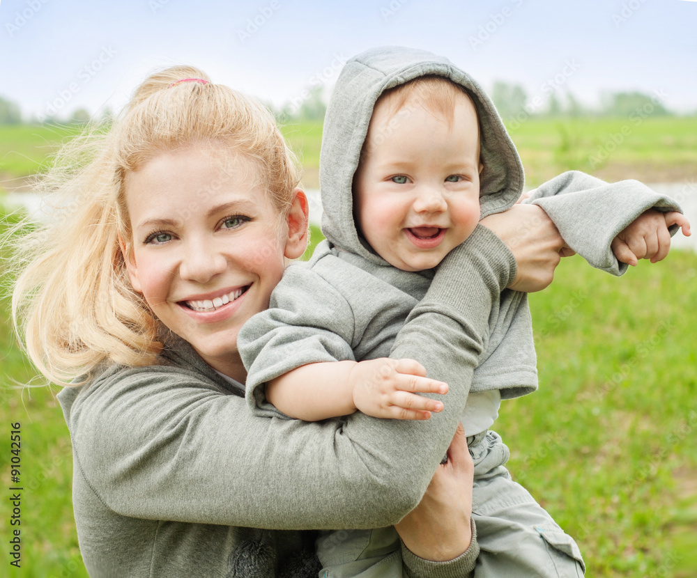 Beautiful Mother And Baby outdoors. Nature. Mum and her Child pl Beautiful Mother And Baby outdoors. Nature. Mum and her Child pl