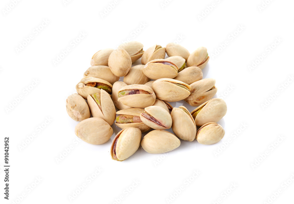 pile of salted pistachio nuts on white background pile of salted pistachio nuts on white background