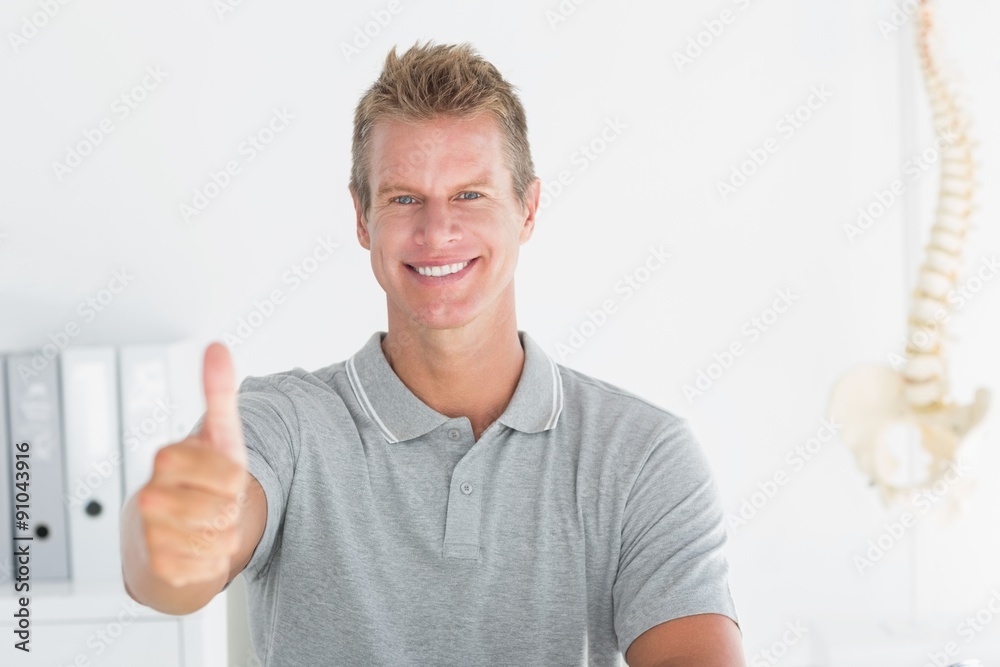 Happy doctor looking at camera with thumbs up Happy doctor looking at camera with thumbs up