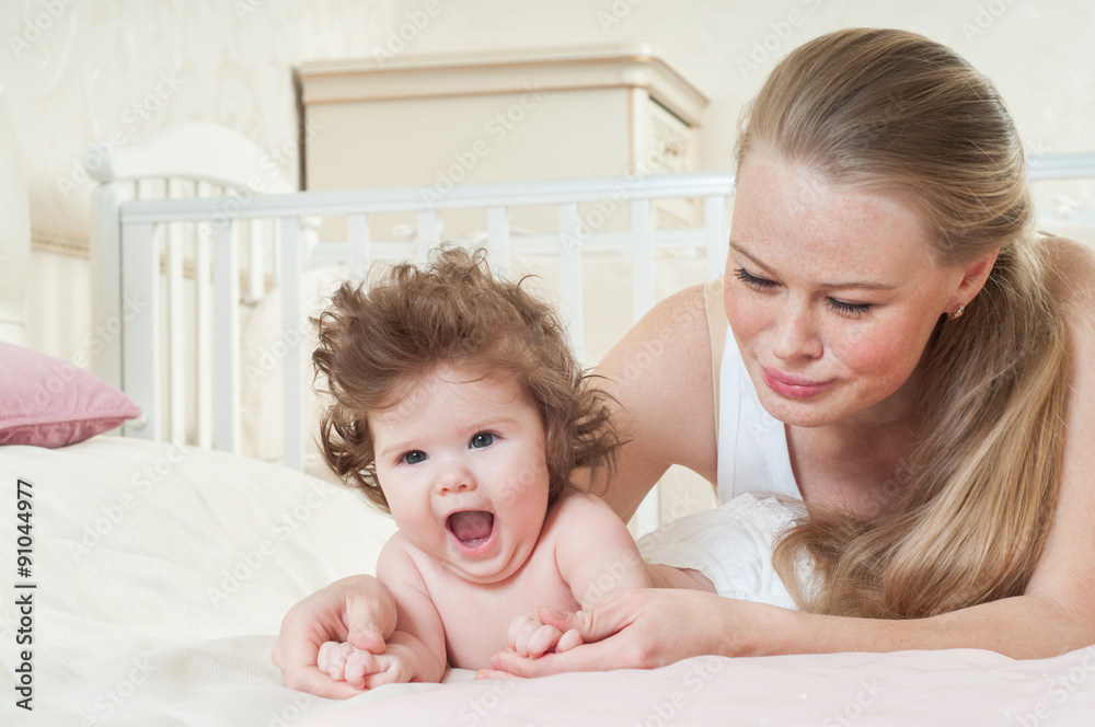 Mother and baby playing and smiling. Happy family. Mother and baby playing and smiling. Happy family.
