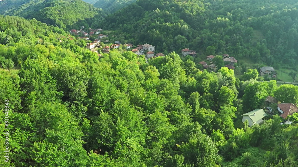 AERIAL view. Flying over countryside village in the mountain meadow AERIAL view. Flying over countryside village in the mountain meadow