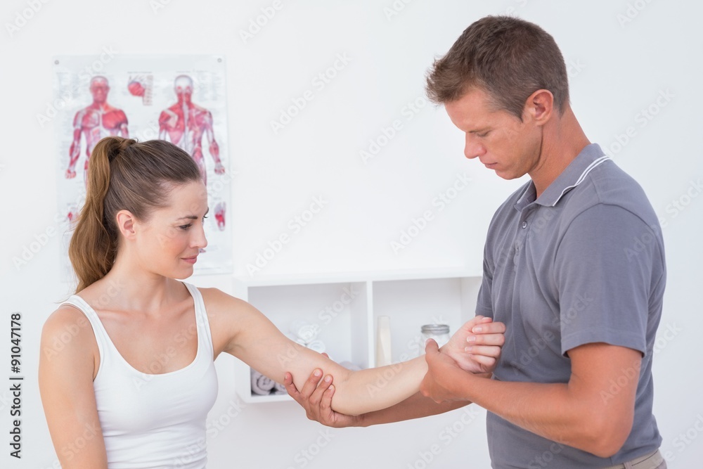 Doctor examining his patient arm Doctor examining his patient arm